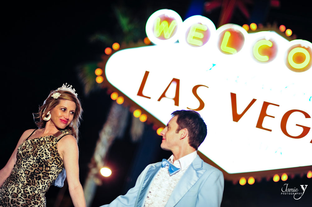 Wedding photography taken of bride and groom outside at night at the famous welcome to las vegas sign
