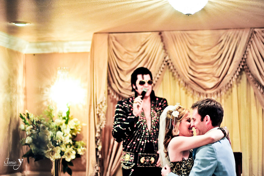 Photograph of bride and groom at las vegas chapel with elvis in the background.