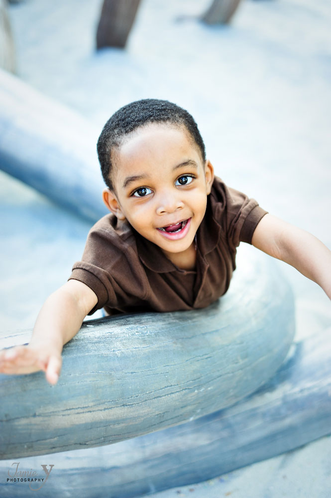 Photograph of young boy smiling at playground at the springs preserve in las vegas.