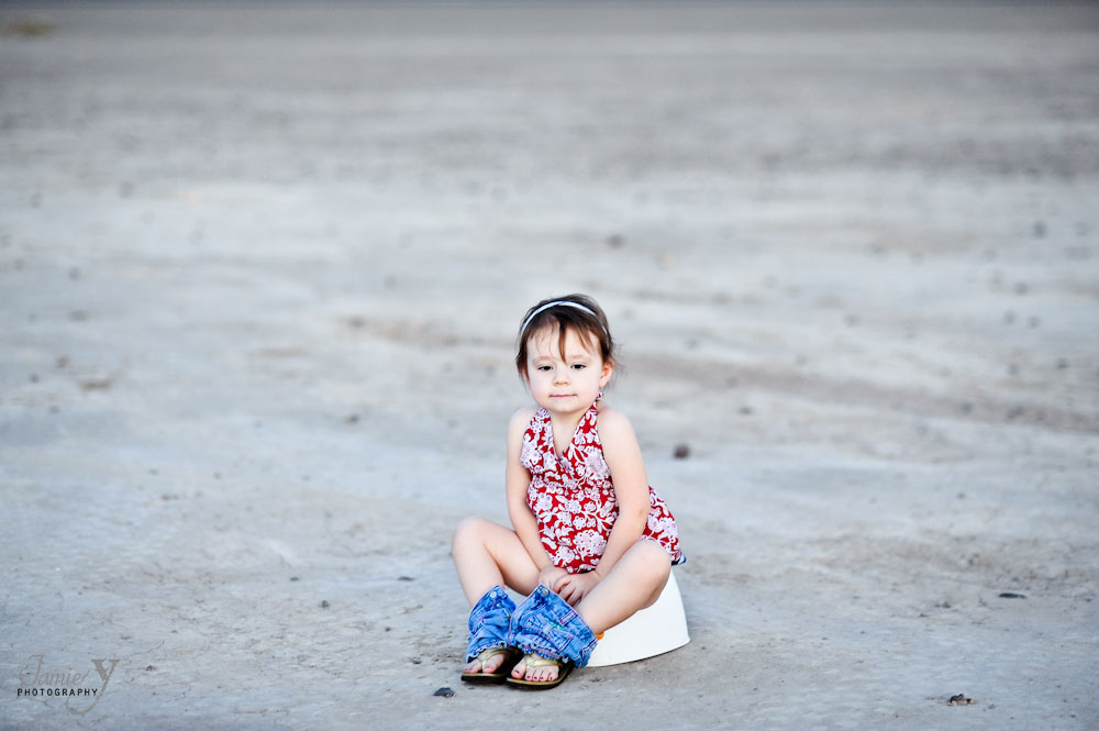 Photograph of young girl sitting on toilet in the desert in las vegas