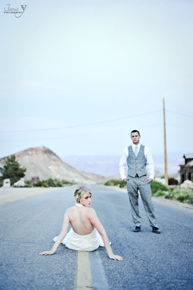 Bride sitting in middle of street with groom in background at nelson's landing