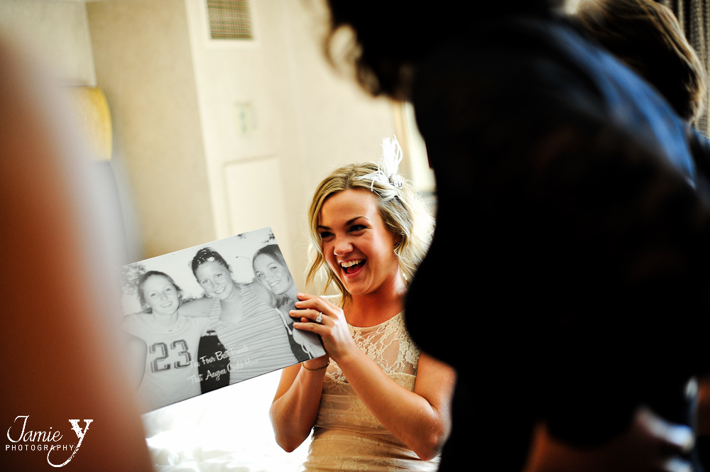 bride to be looking at a photo book from her best friends given as a gift
