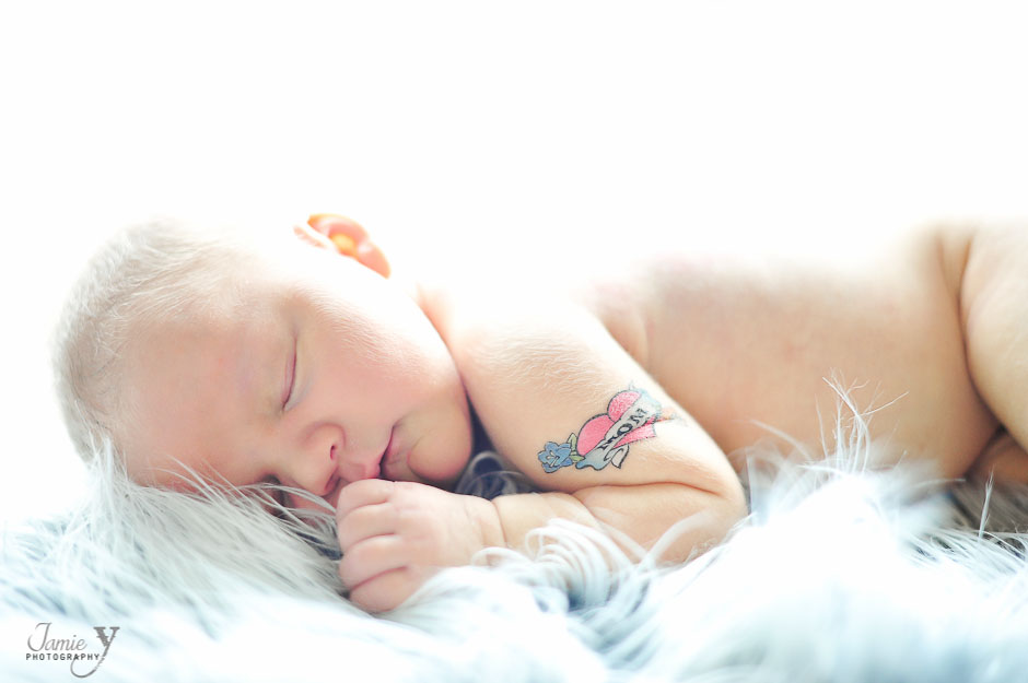 newborn photography with tattoo on arm