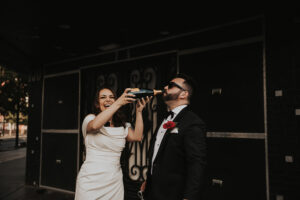 bride and groom drinking champagne in downtown las vegas