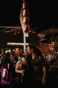 bride and groom in black in downtown las vegas kissing