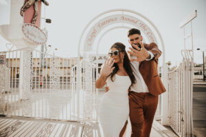 paparazzi style photo of bride and groom leaving little white chapel in las vegas