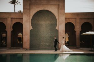 bride and groom walking by pool at amajena morocco
