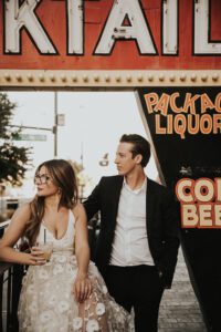 bride and groom in front of atomic liquor neon sign downtown las vegas