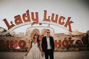 bride and groom in front of neon sign at the neon museum in downtown las vegas