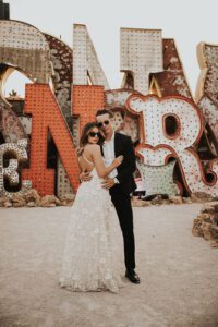 bride and groom in front of neon sign at the neon museum in downtown las vegas