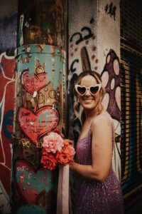 bride with pink fringe dress and heart sunglasses