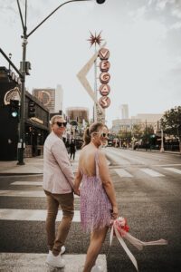 bride and groom in front of vegas neon sign