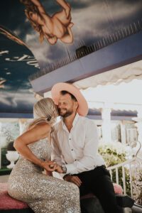 bride and groom in pink cadillac ceremony at little white chapel