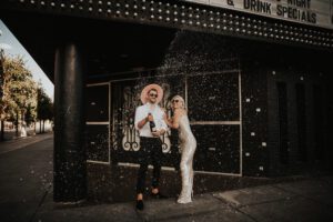 bride and groom popping champagne in downtown las vegas