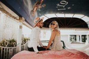 bride and groom in pink cadillac ceremony at little white chapel