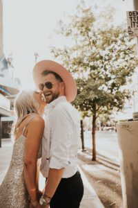 warm backlit photo of bride and groom in downtown las vegas with neon signs behind