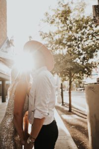 warm backlit photo of bride and groom in downtown las vegas with neon signs behind