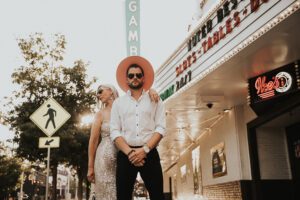 warm backlit photo of bride and groom in downtown las vegas with neon signs behind