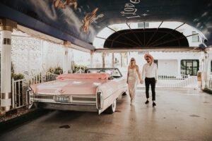 bride and groom in pink cadillac ceremony at little white chapel