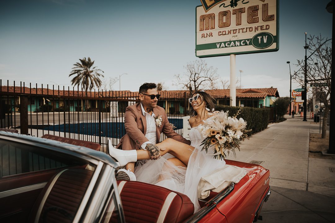 rock n roll bride and groom in vintage car