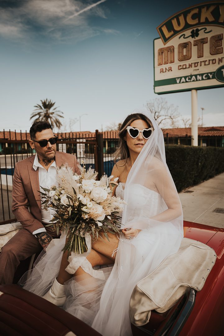 rock n roll bride and groom in vintage car