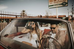 rock n roll bride and groom in vintage car