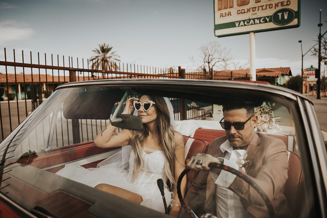 rock n roll bride and groom in vintage car