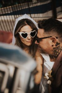 rock n roll bride and groom in vintage car