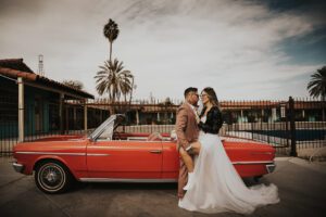 rock n roll bride and groom in vintage car