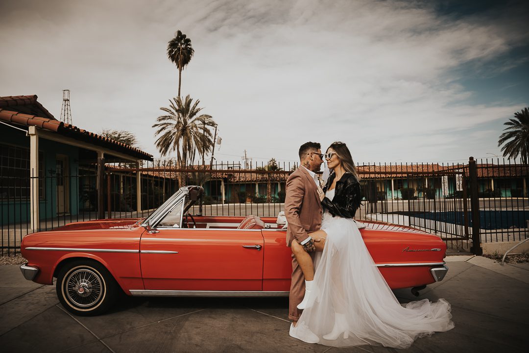 rock n roll bride and groom in vintage car