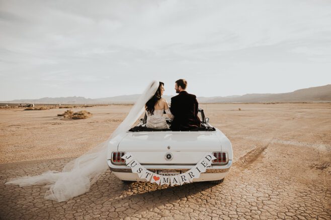 elopement couple in las vegas at dry lake bed in spring just them and a vintage car